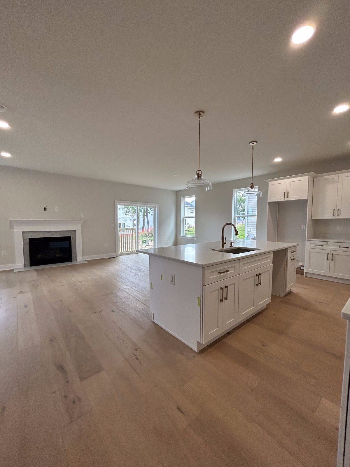 Model 1 kitchen open to the family room with fireplace