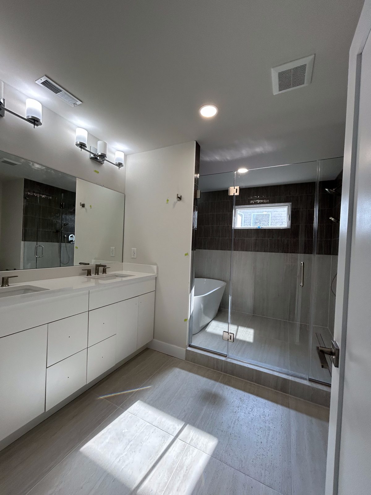 Model 1 primary bathroom with double vanity and glass shower