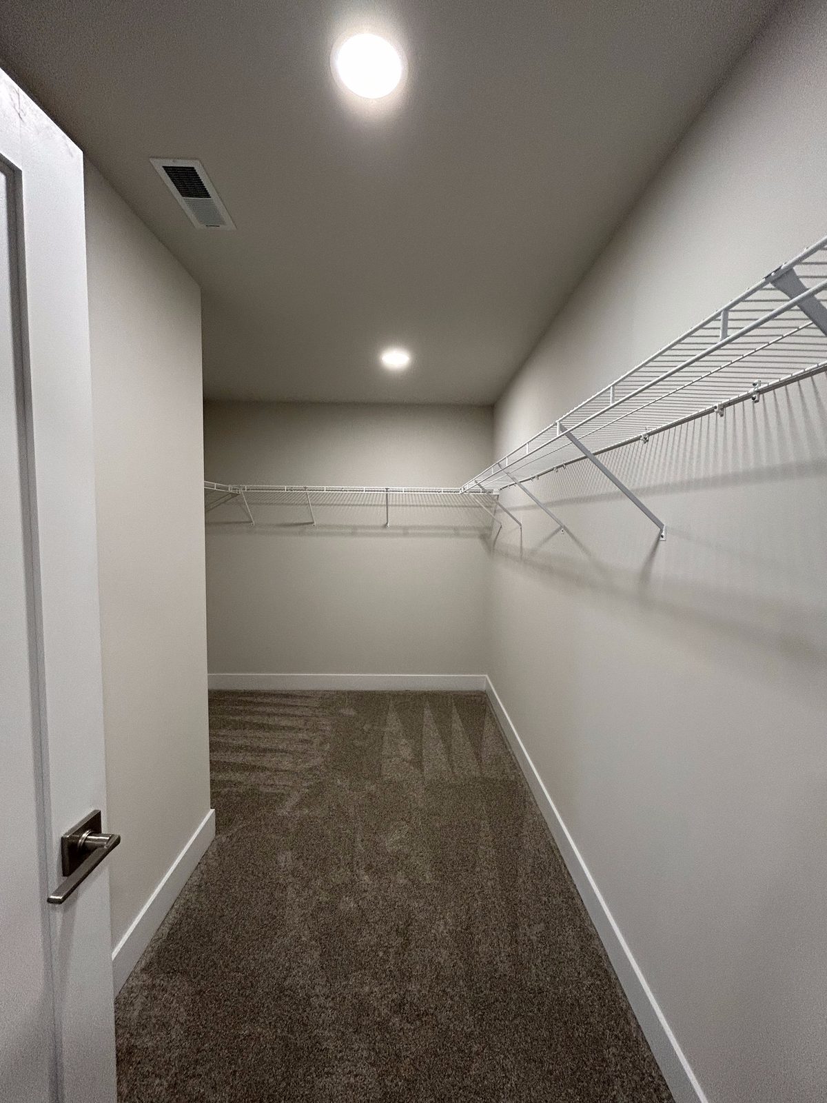 Model 1 primary suite walk-in closet with wire shelving