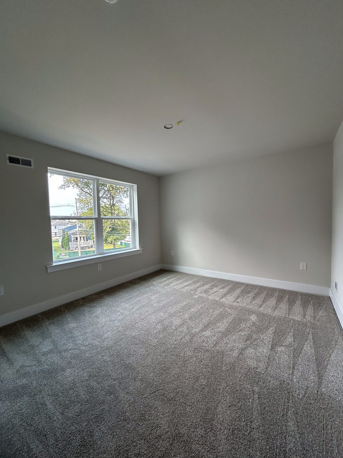 Model 1 upstairs bedroom, unfurnished, corner windows