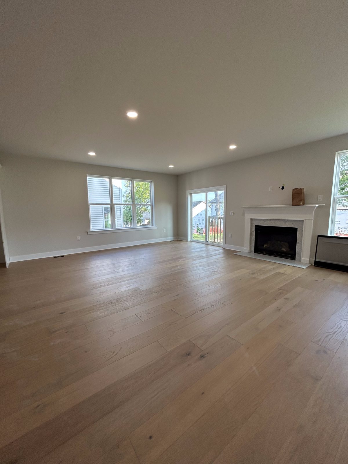 Model 2 great room with fireplace and wood flooring